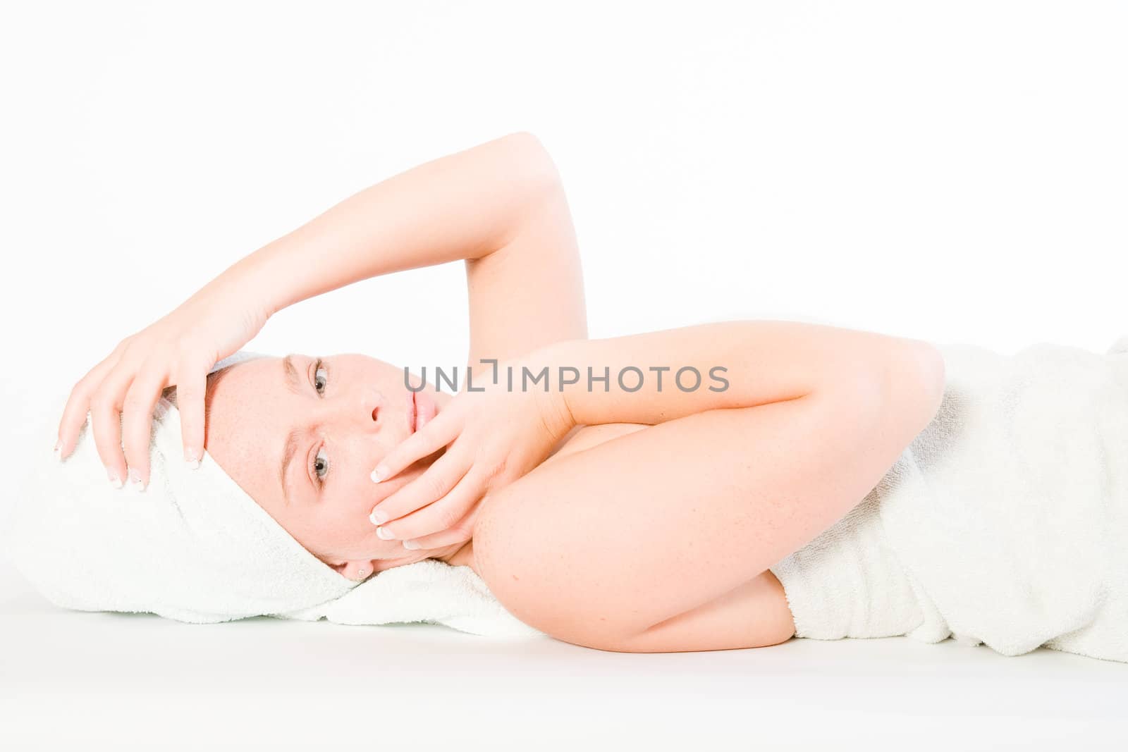 Studio portrait of a spa girl fondling her head