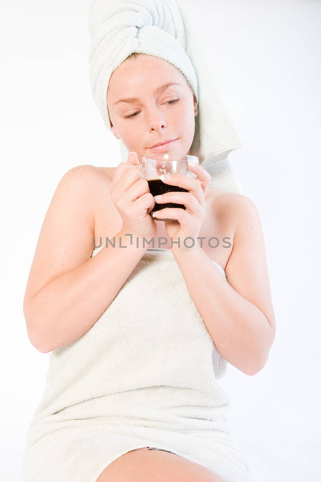 Studio portrait of a spa girl dreaming while drinking coffee