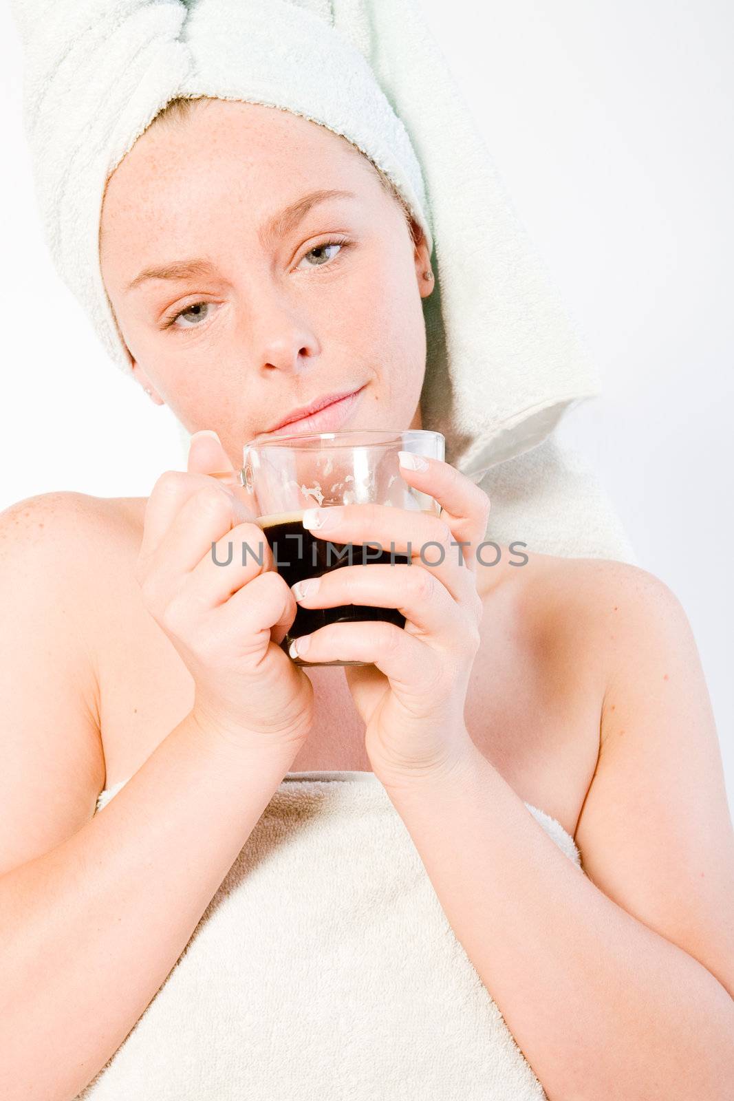Studio portrait of a spa girl drinking coffee and waking up