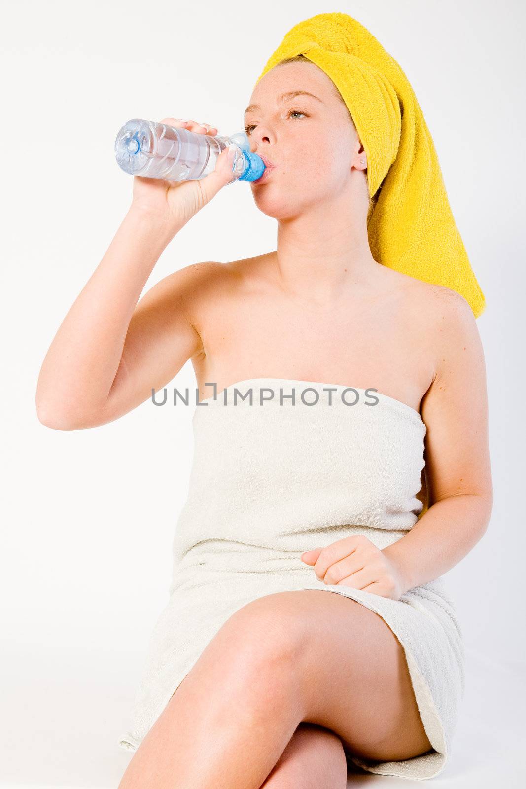 Studio portrait of a spa girl drinking