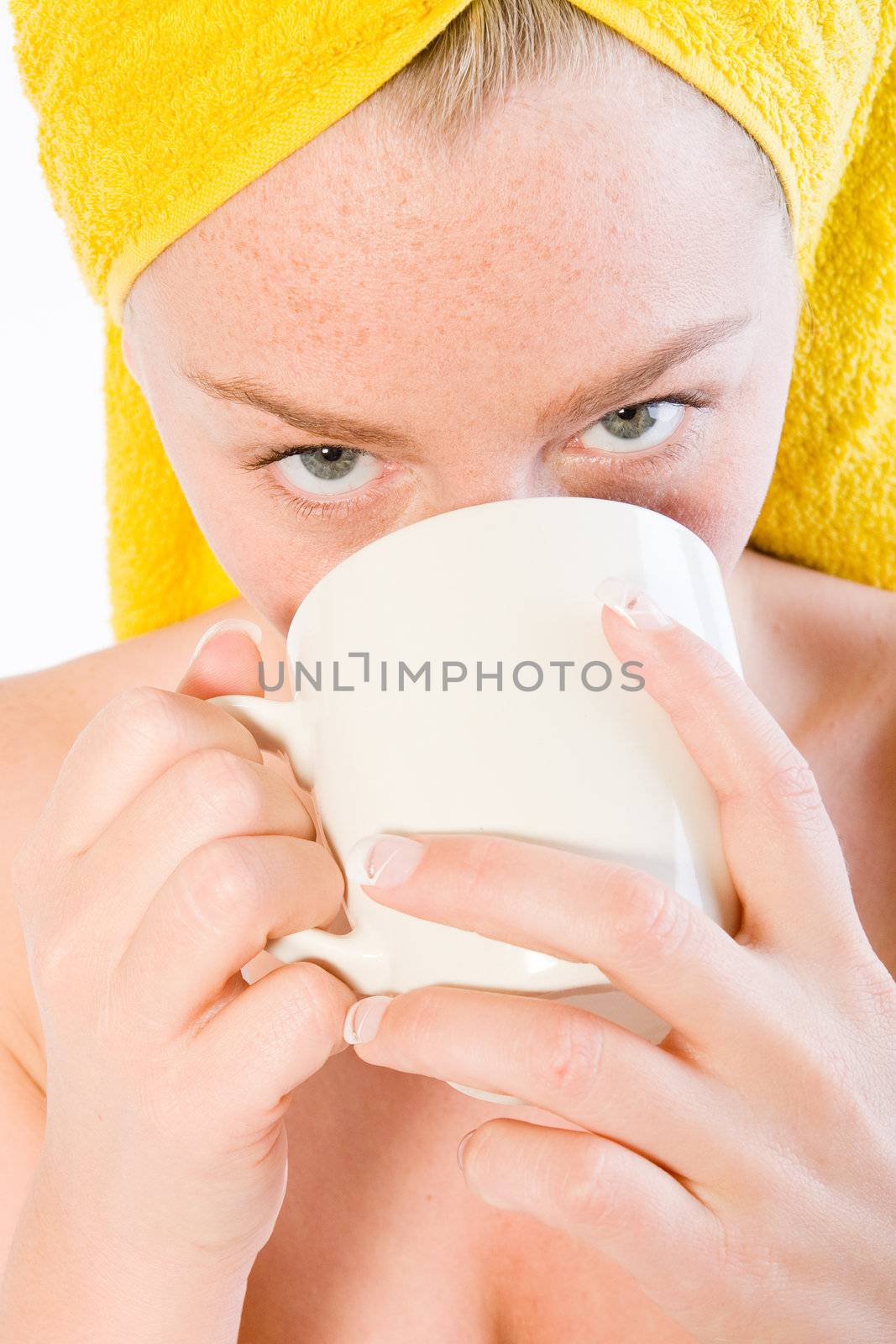 Studio portrait of a spa girl drinking coffee up close