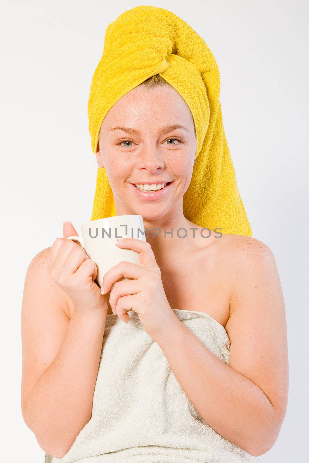 Studio portrait of a spa girl drinking coffee and listening