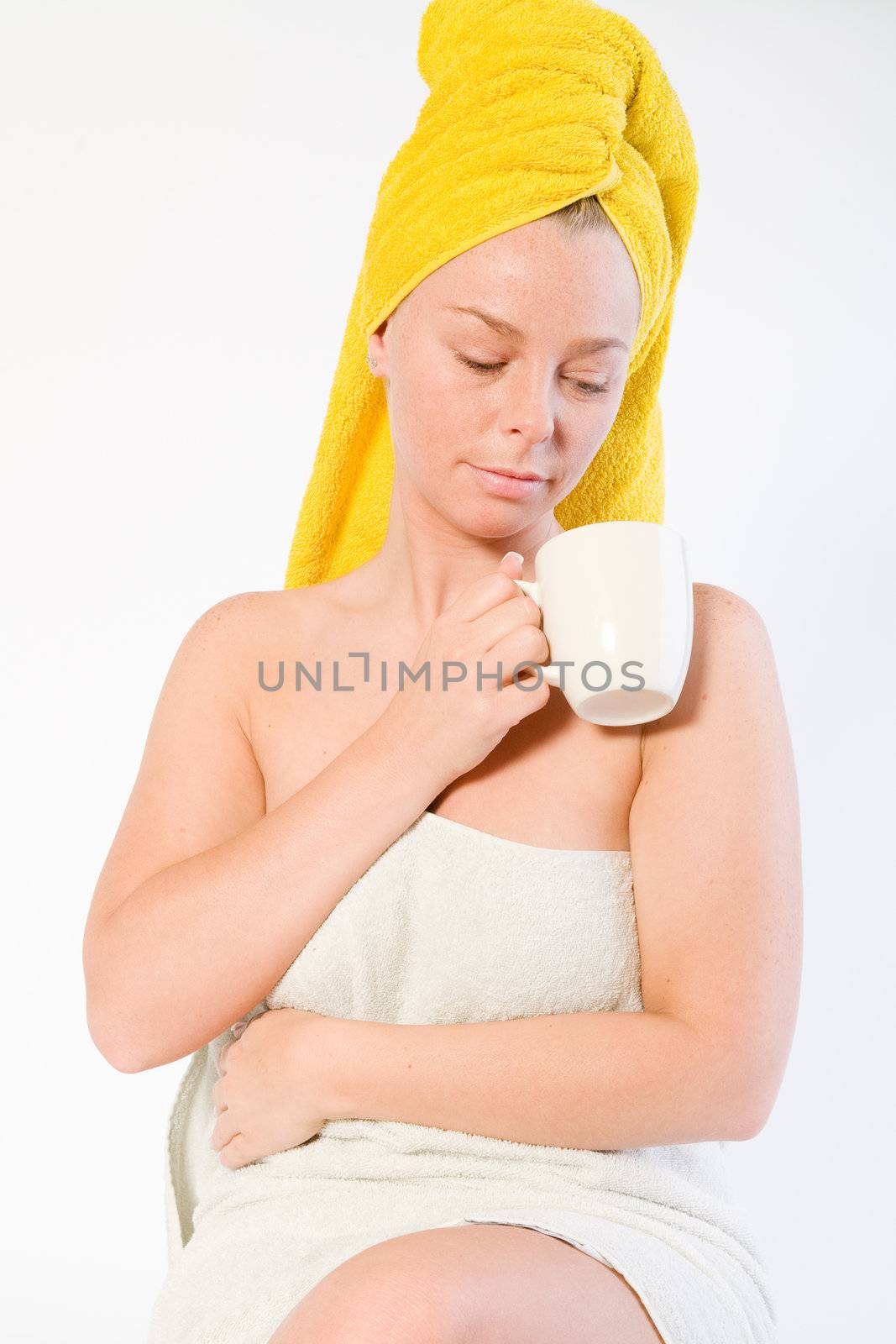 Studio portrait of a spa girl looking into her coffee