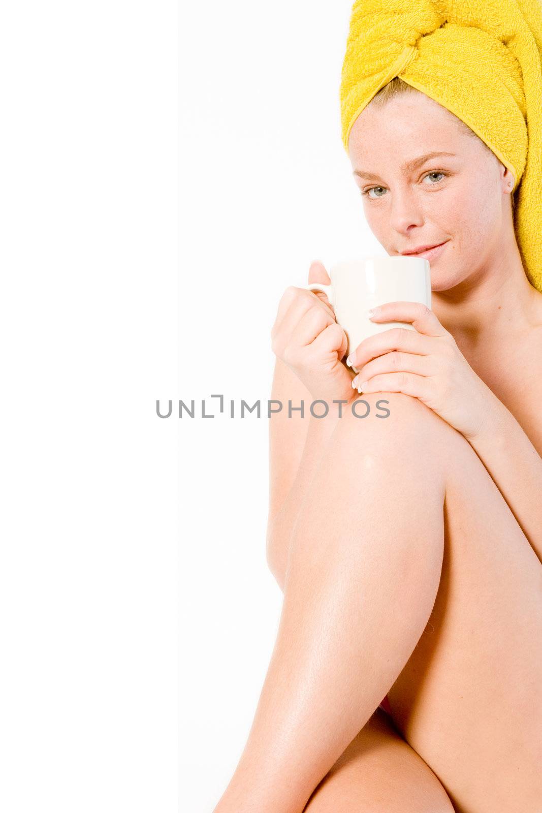 Studio portrait of a spa girl drinking coffee with her leg up