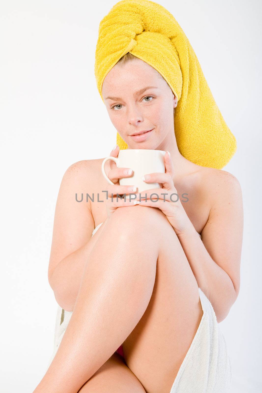 Studio portrait of a spa girl drinking coffee and listening