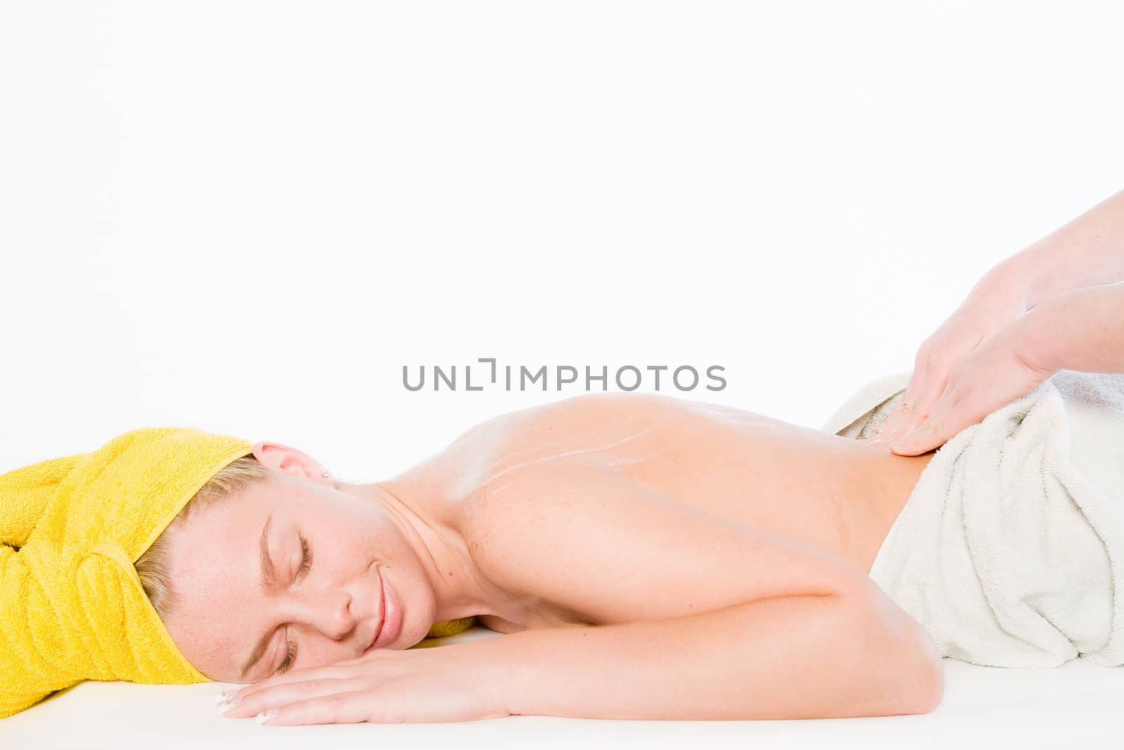 Studio portrait of a spa girl getting a back rub
