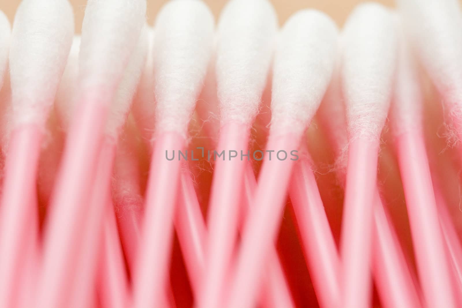 line of cotton buds with pink plastic basis