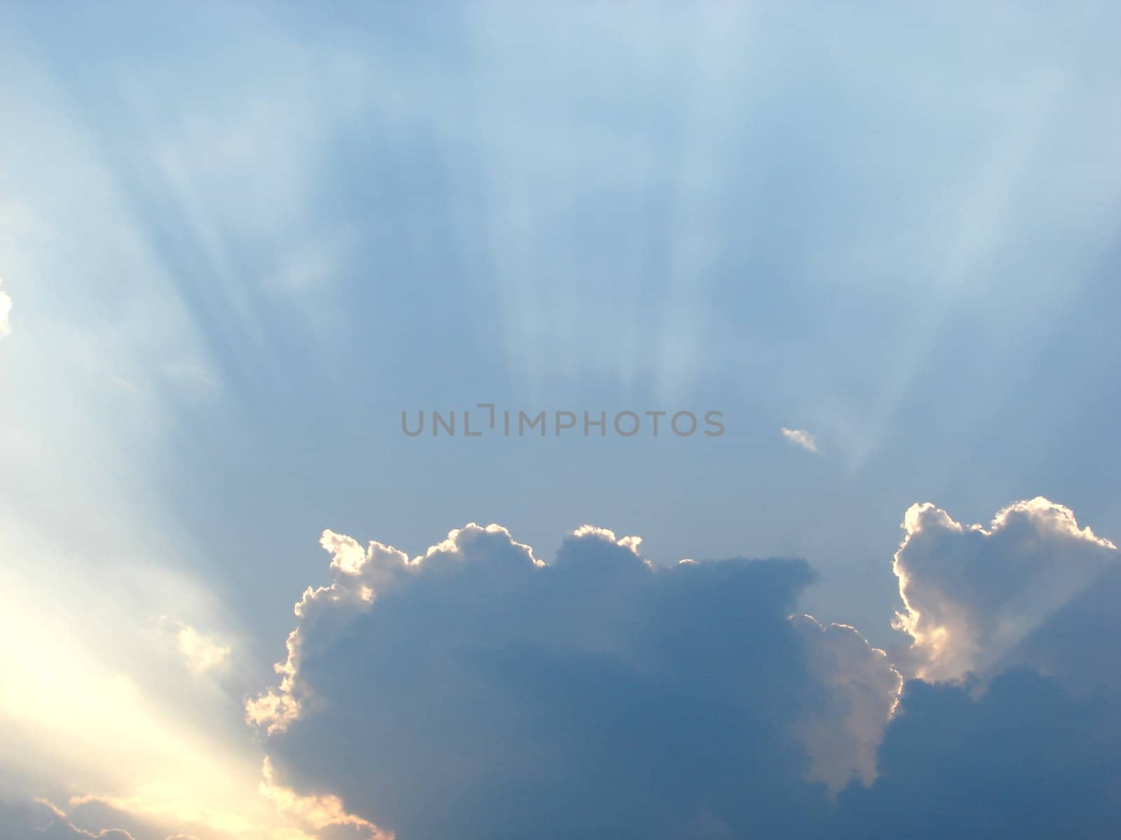 Clouds and sunrays in the sky