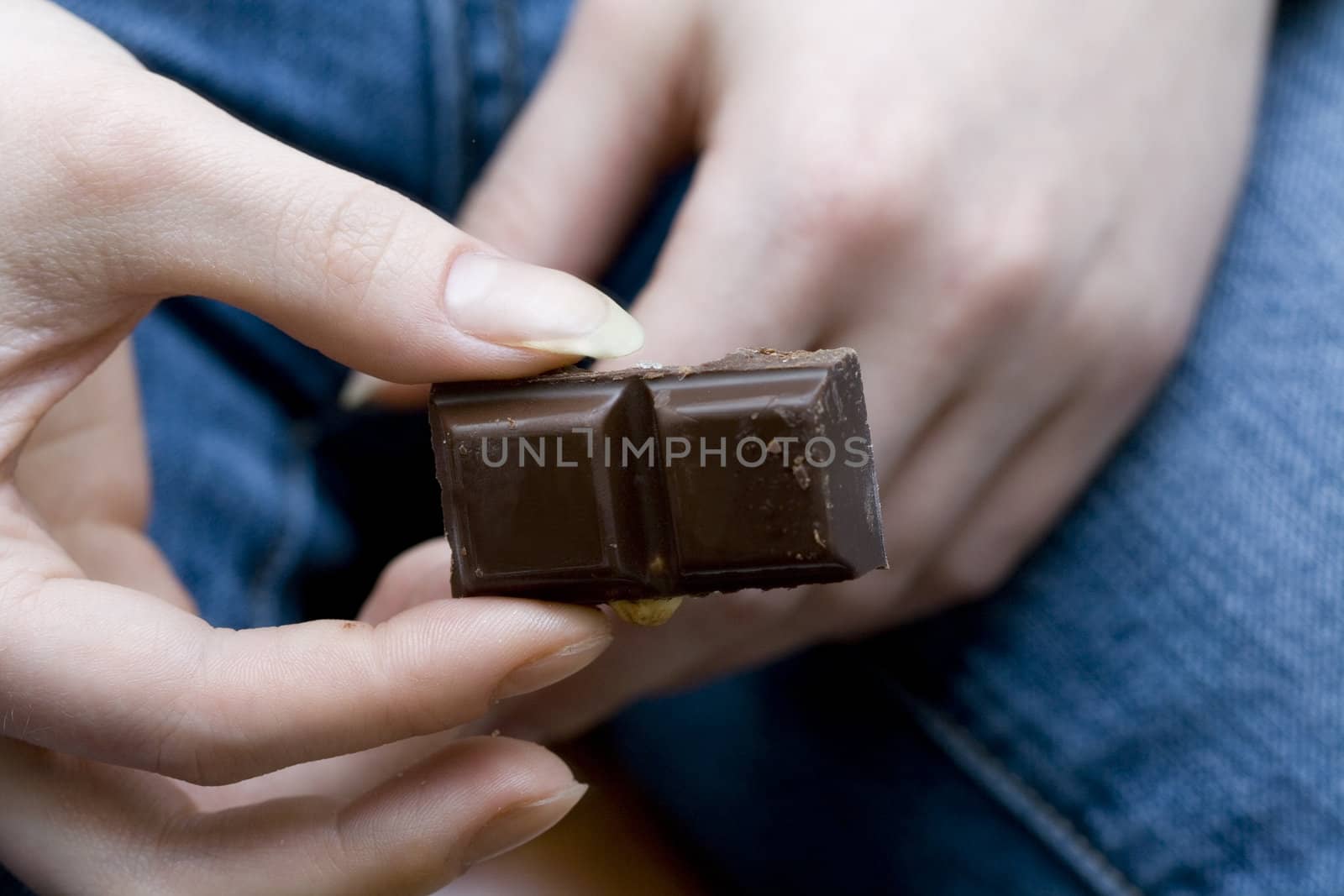 chocolate pieces in woman's hands by Sethislav