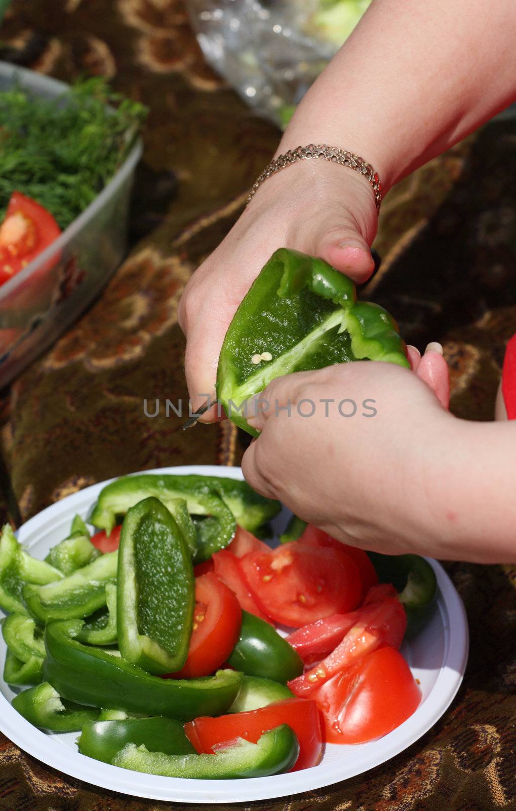 Hands of the girl cut sweet pepper  by fedlog