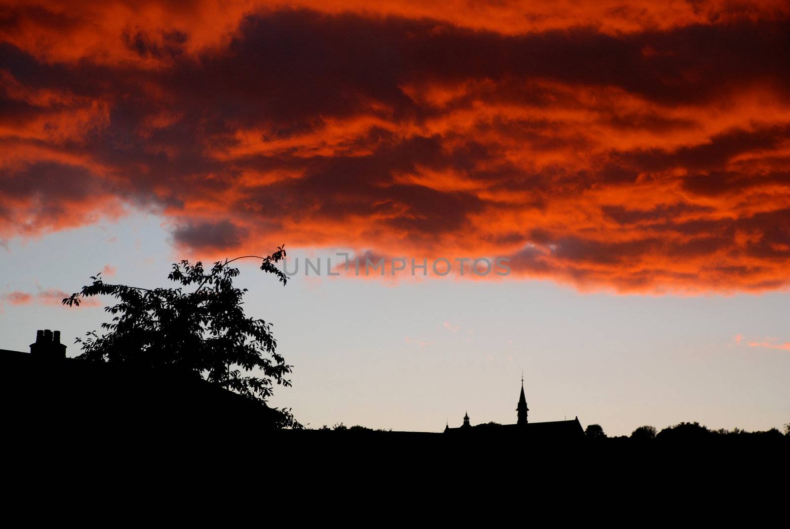 A stunning, naturally-occurring sunset phenomenon over an urban landscape