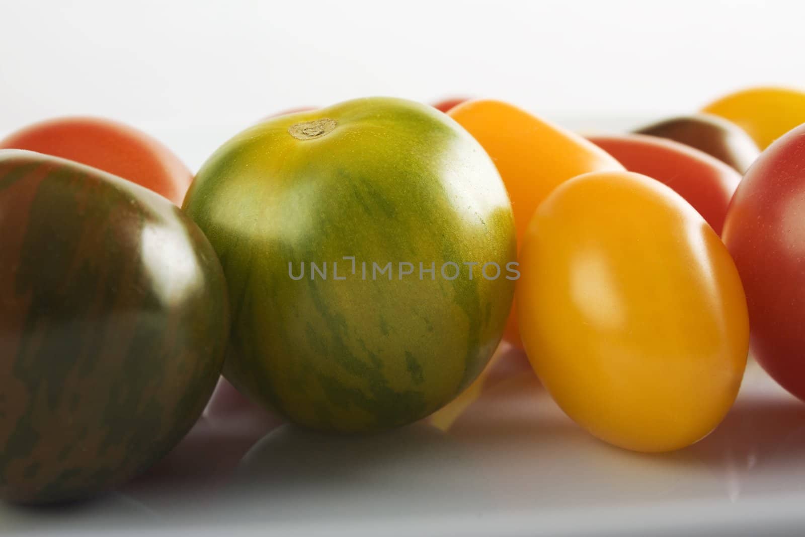 Colorful varieties of fresh ripe cherry tomatoes.