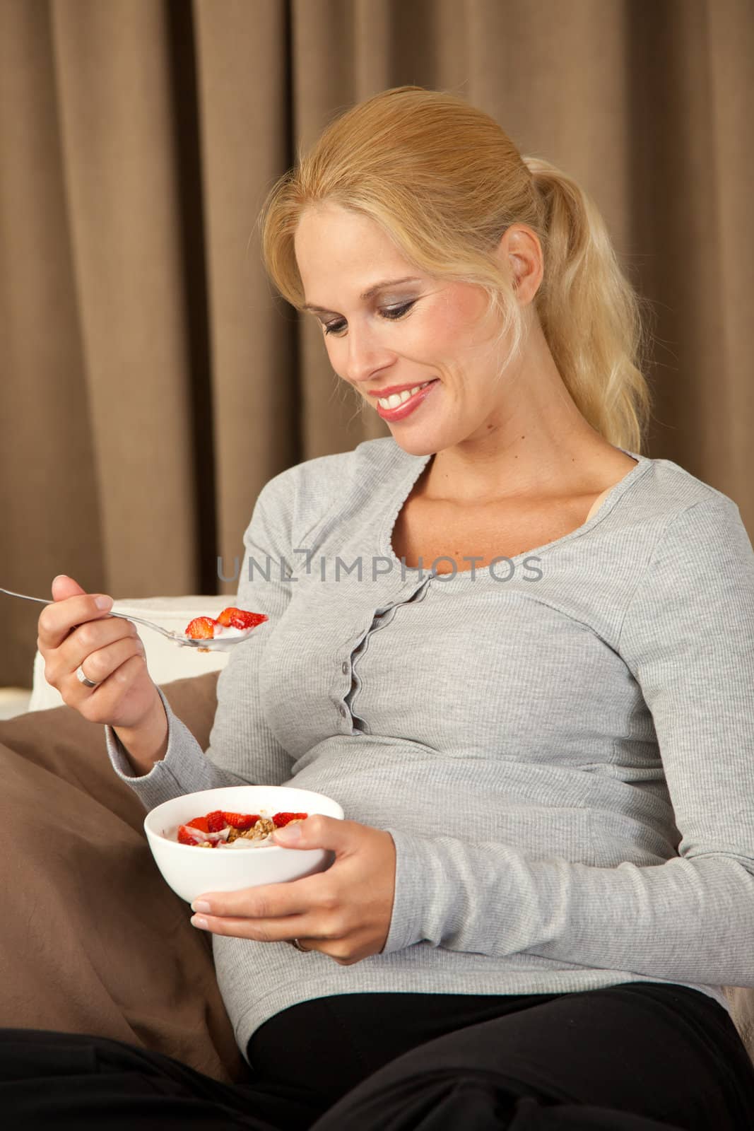 Beautiful pregnant woman having a very healthy lunch