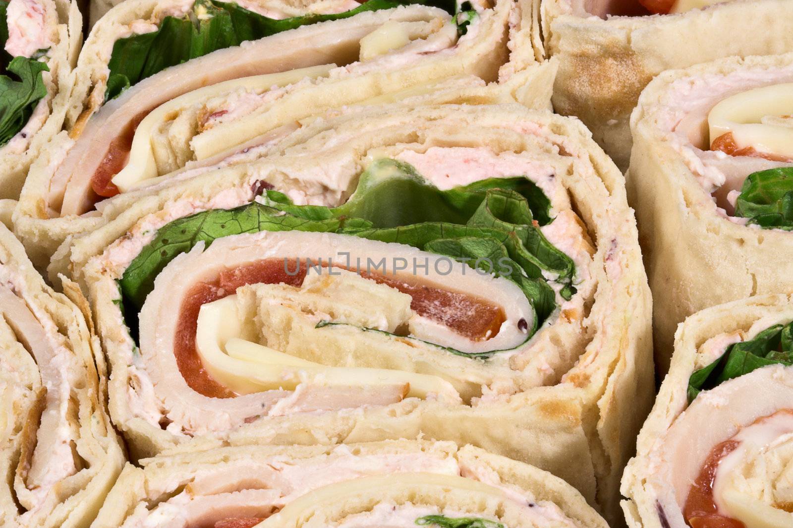 A sliced turkey wrap sandwich
