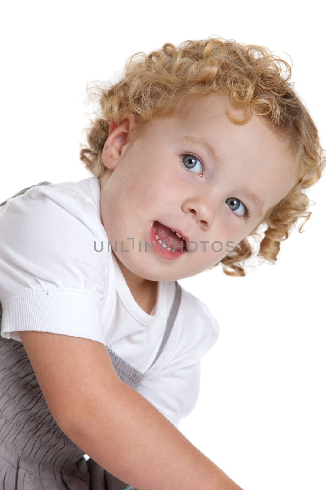 Adorable three year old girl with blond curls on white background