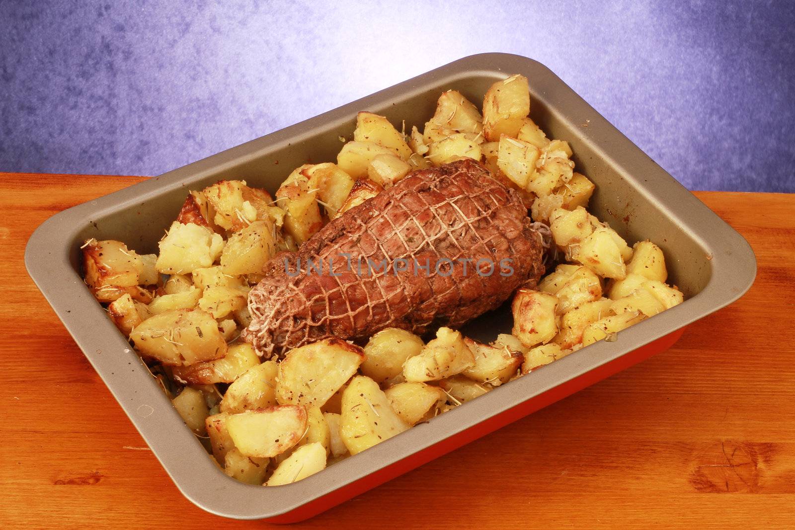 Roast herb-coated lamb with roasted potatoes 