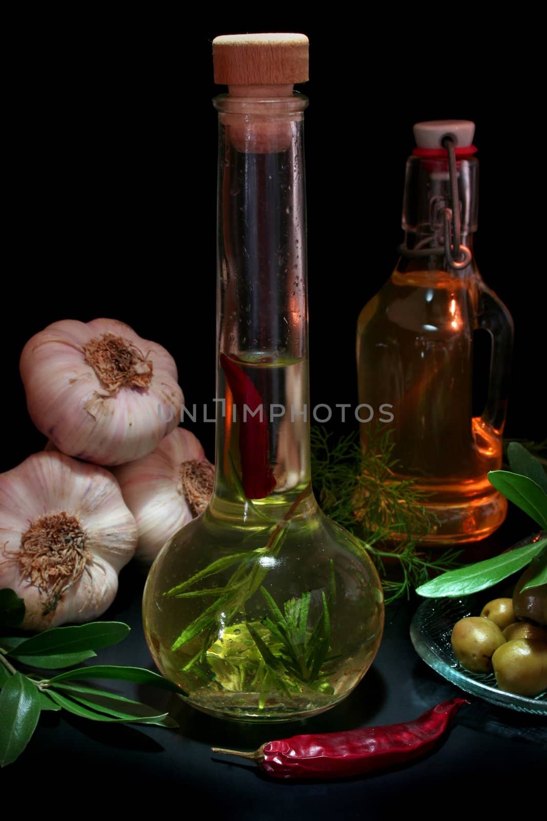 Herbal Oil with olive branch and fresh ingredients