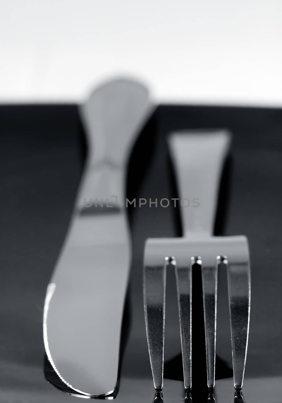 Knife and fork on a dark plate