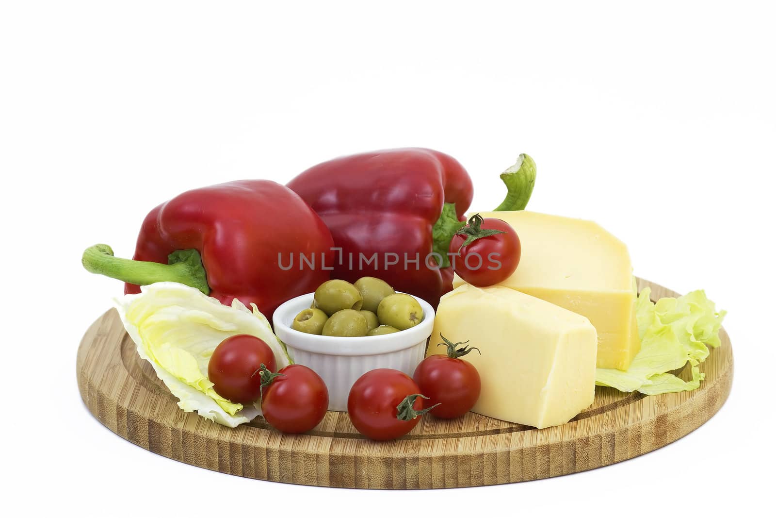 yellow cheese with fresh vegetables isolated on white background 