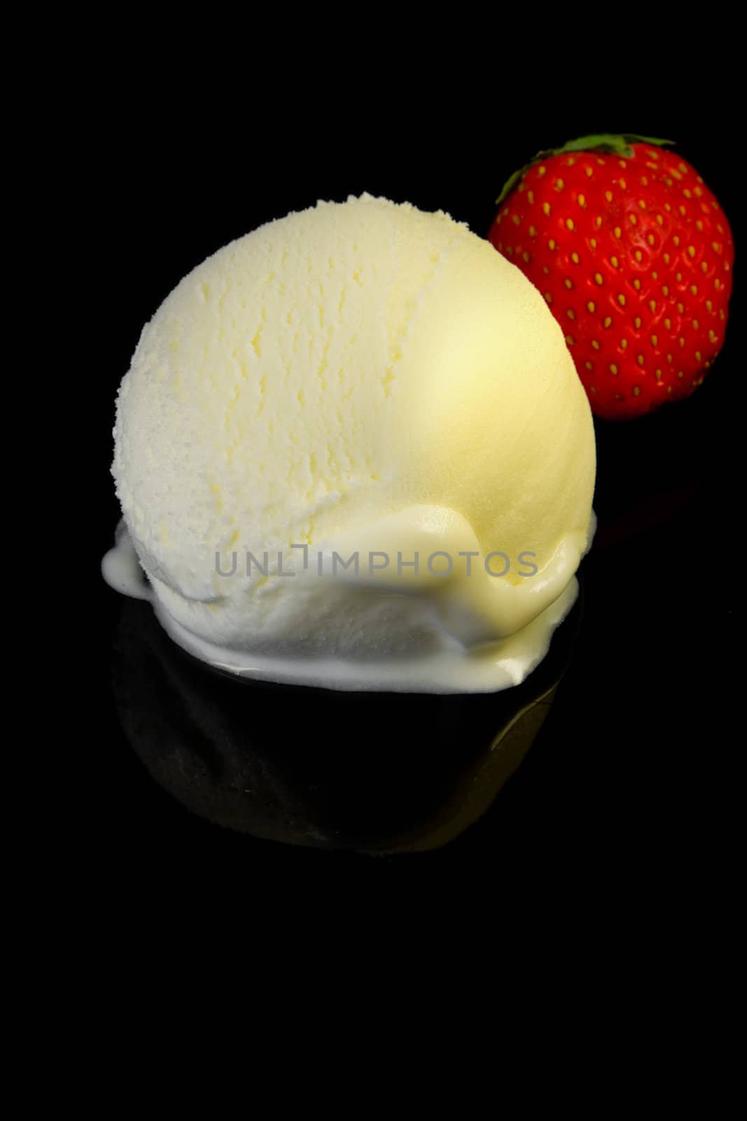 Vanilla ice cream scoop on dark reflective background