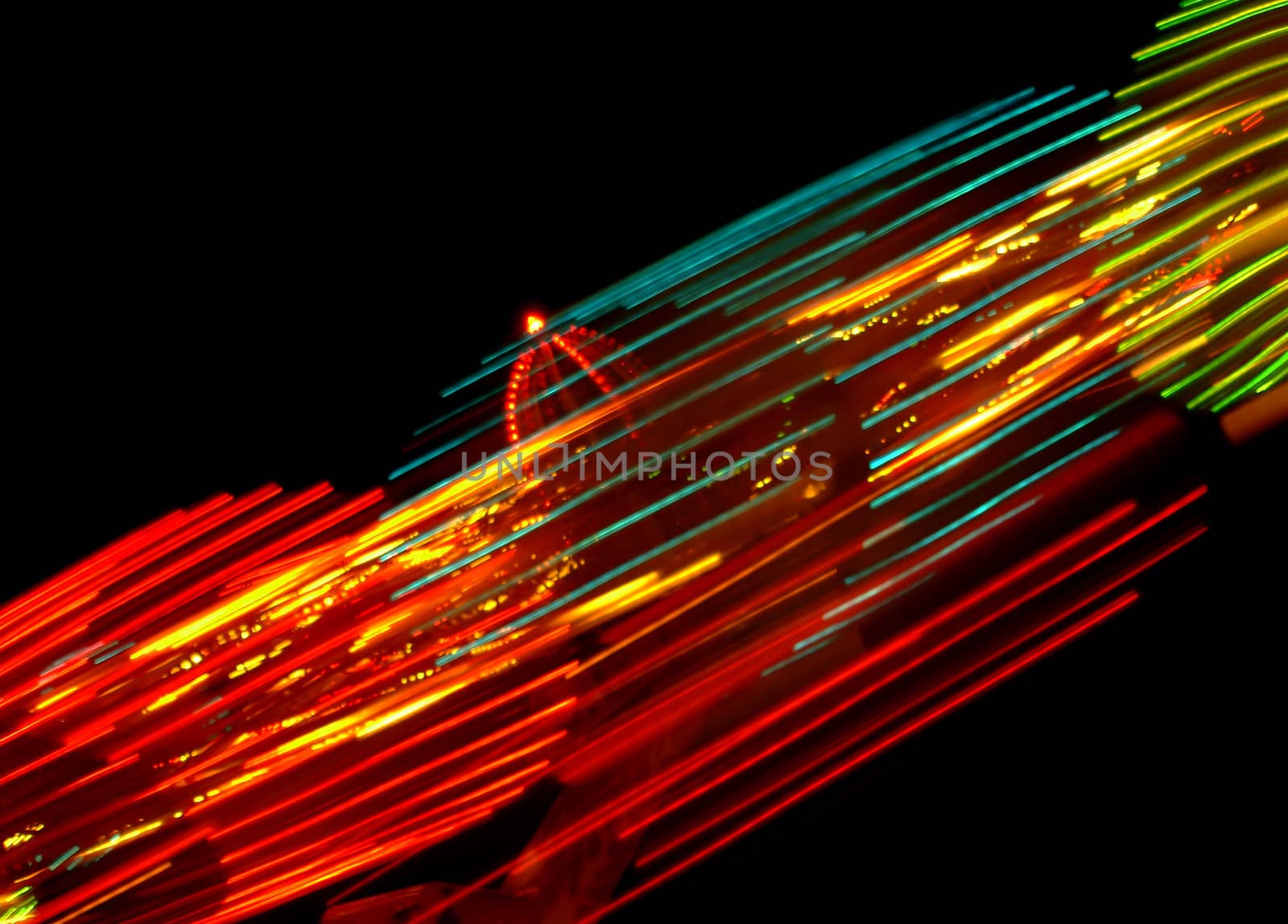 Night photo of a spinner in a entertainment park