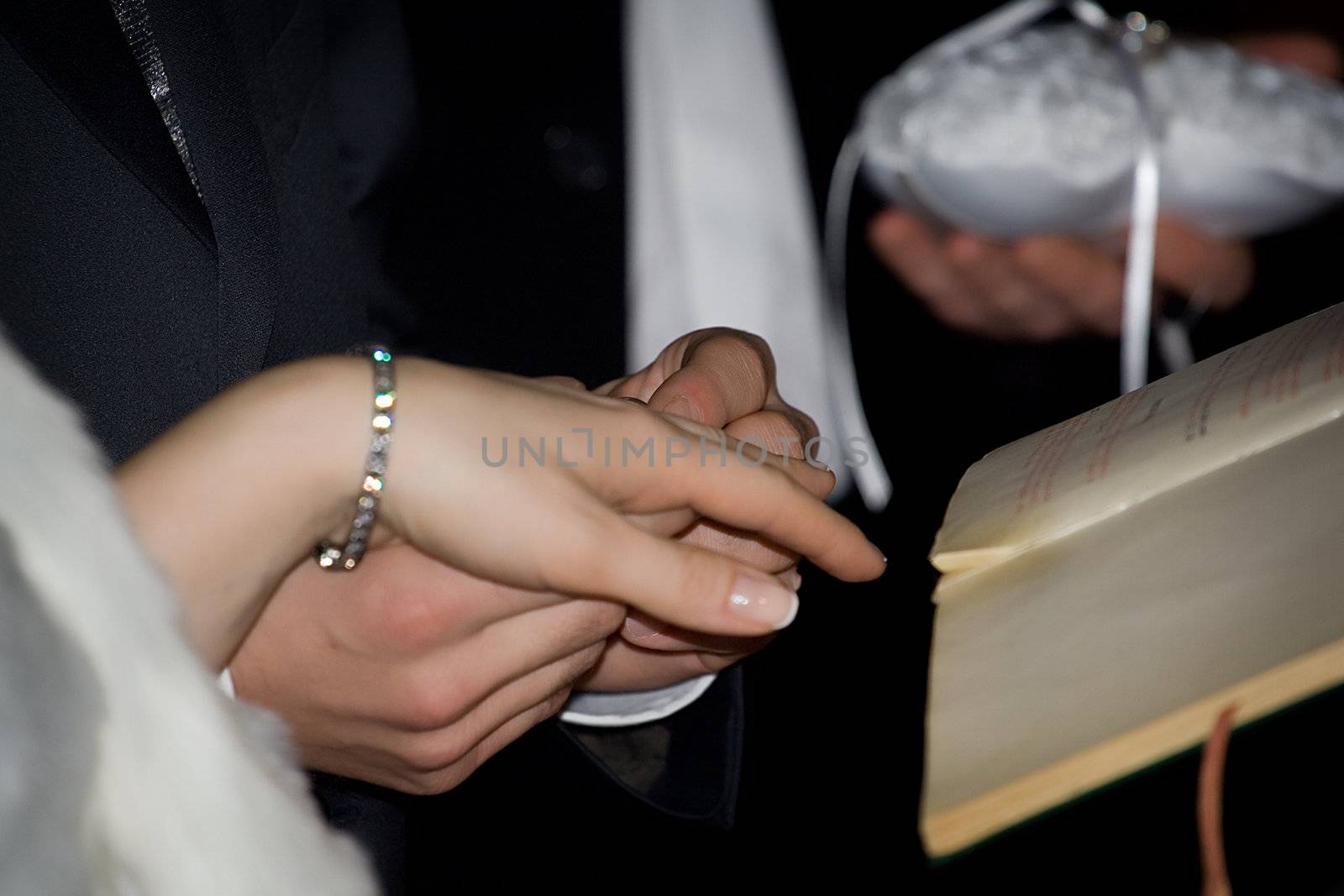 Exchanging rings at a wedding ceremony in the church. Shallow DOF photo