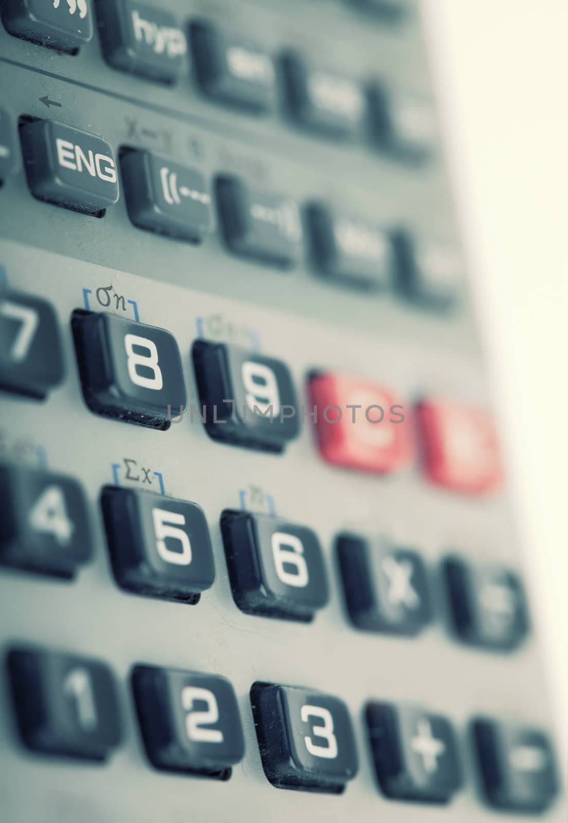 Calculator on white background , close up retro style toned photo with shallow DOF and space for your text