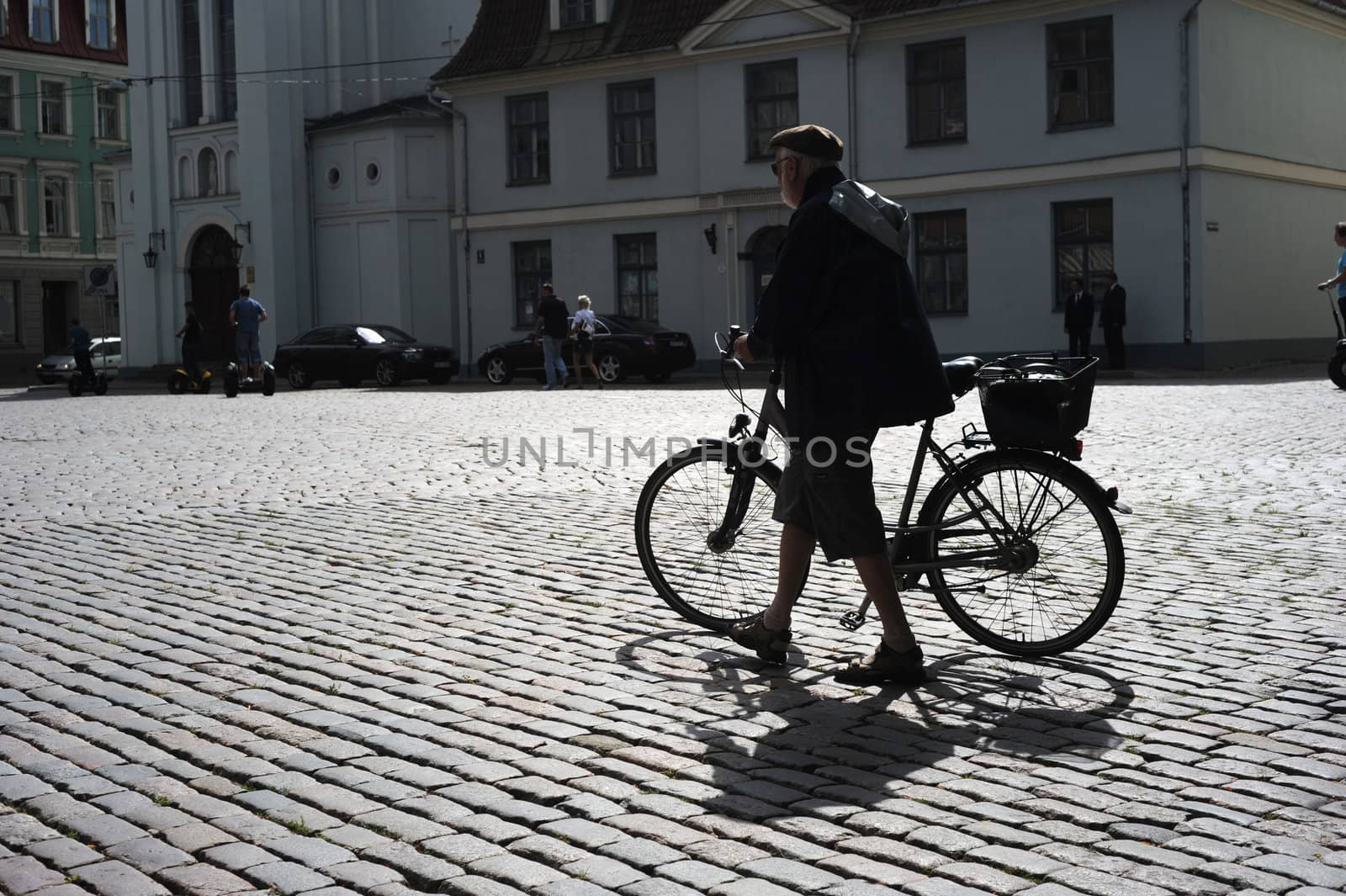 Man walking his bicycle by joyfull