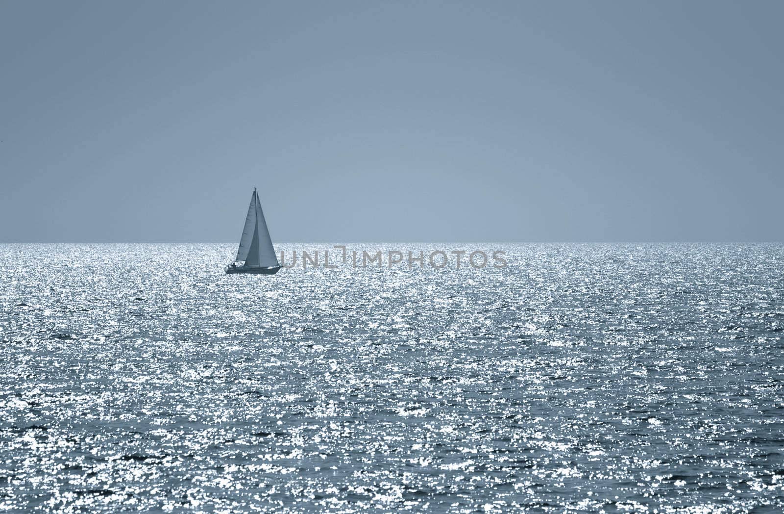 A small boat sailing on a sunny morning , toned photo