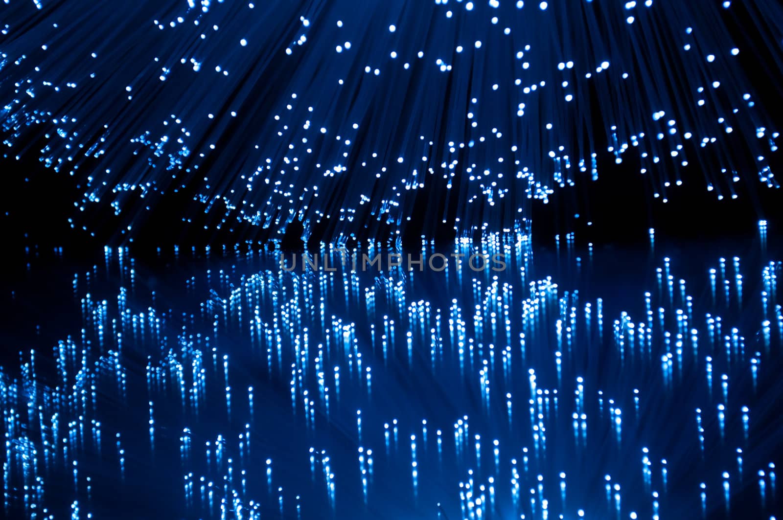 Vibrant blue fibre optic light strands reflecting into foreground.