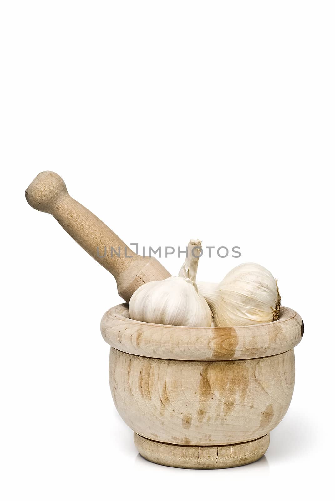 Mortar and pestle with some garlic isolated on a white background.