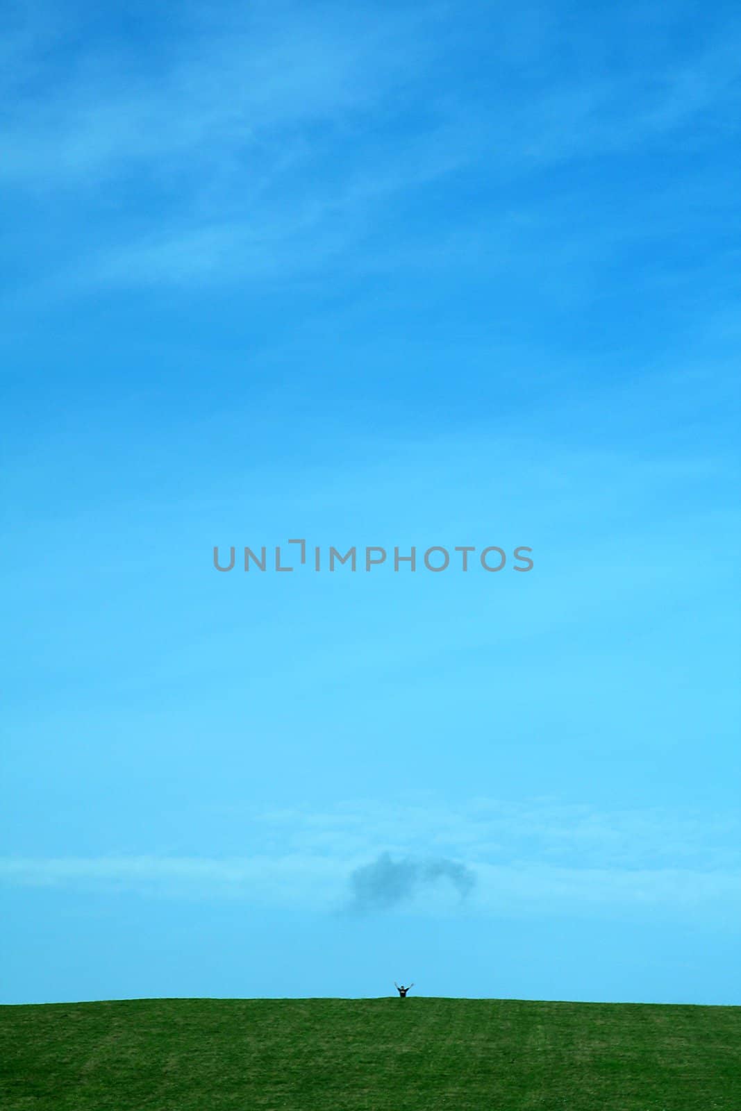 clear blue sky background, small figure in background