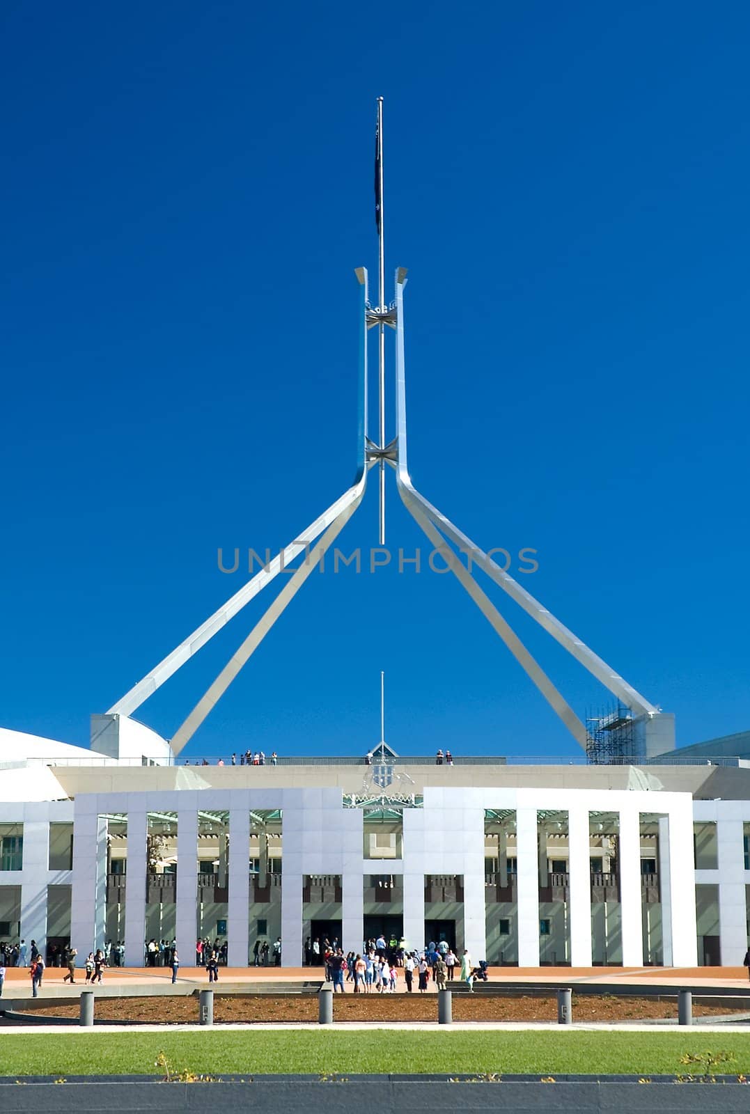 people standing in front of Canberra Parliament House, clear blue sky