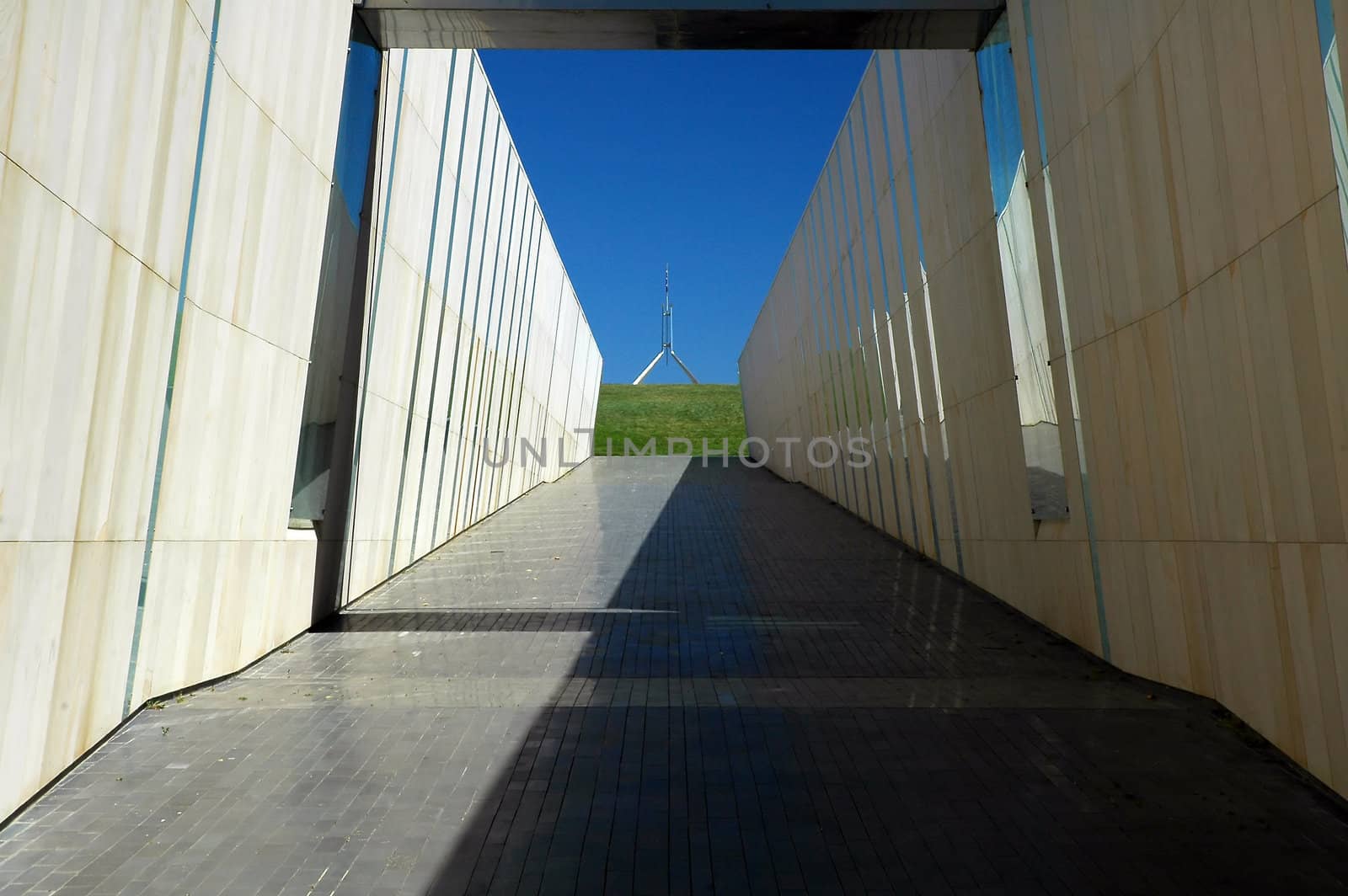 modern construction in Canberra, australian flag on Canberra Parliament House in background