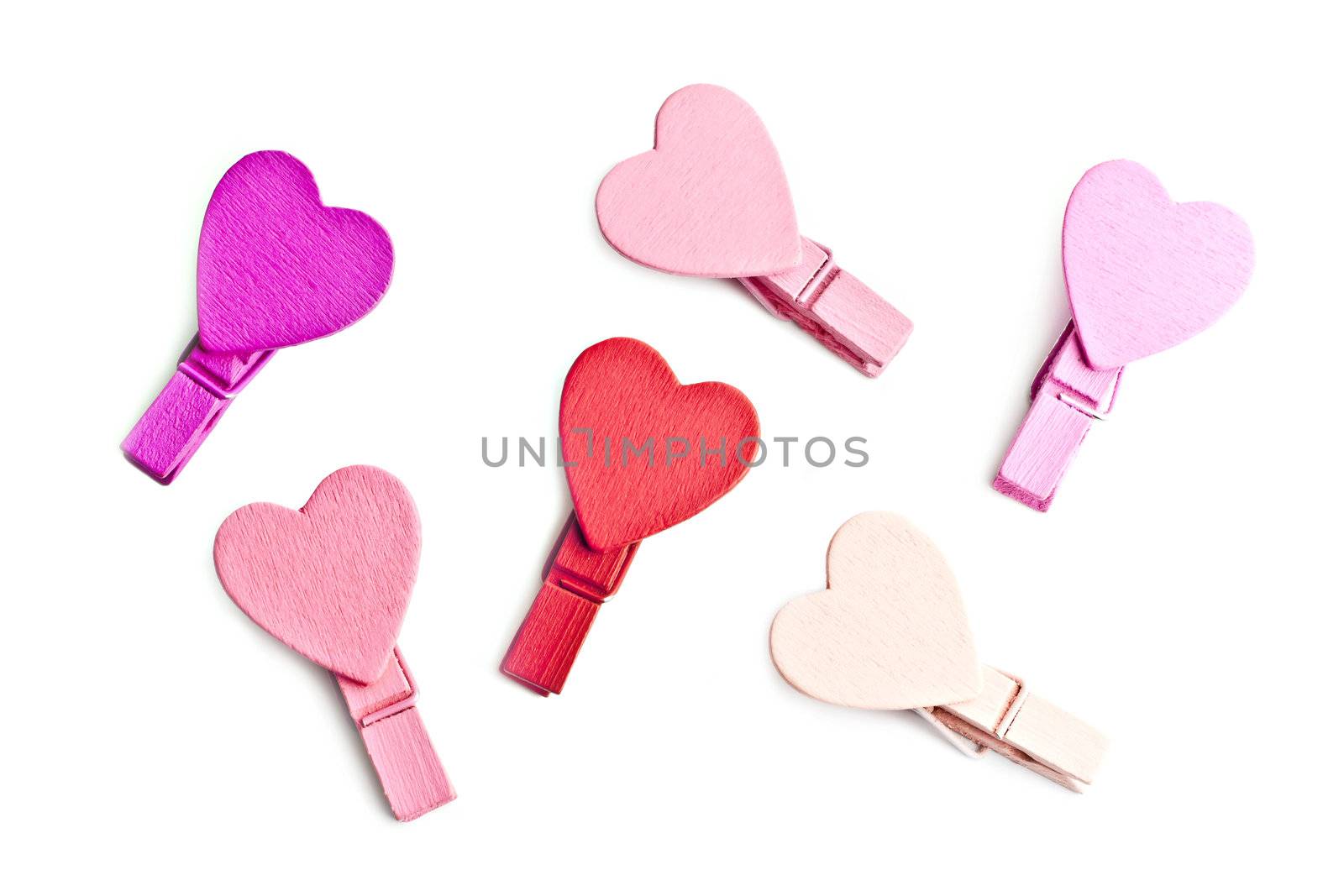 Pegs with a heart on a white background, macro photo by gitusik