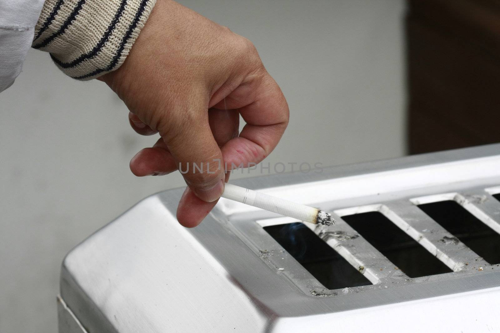 Smoking cigarette in a ash tray concept.