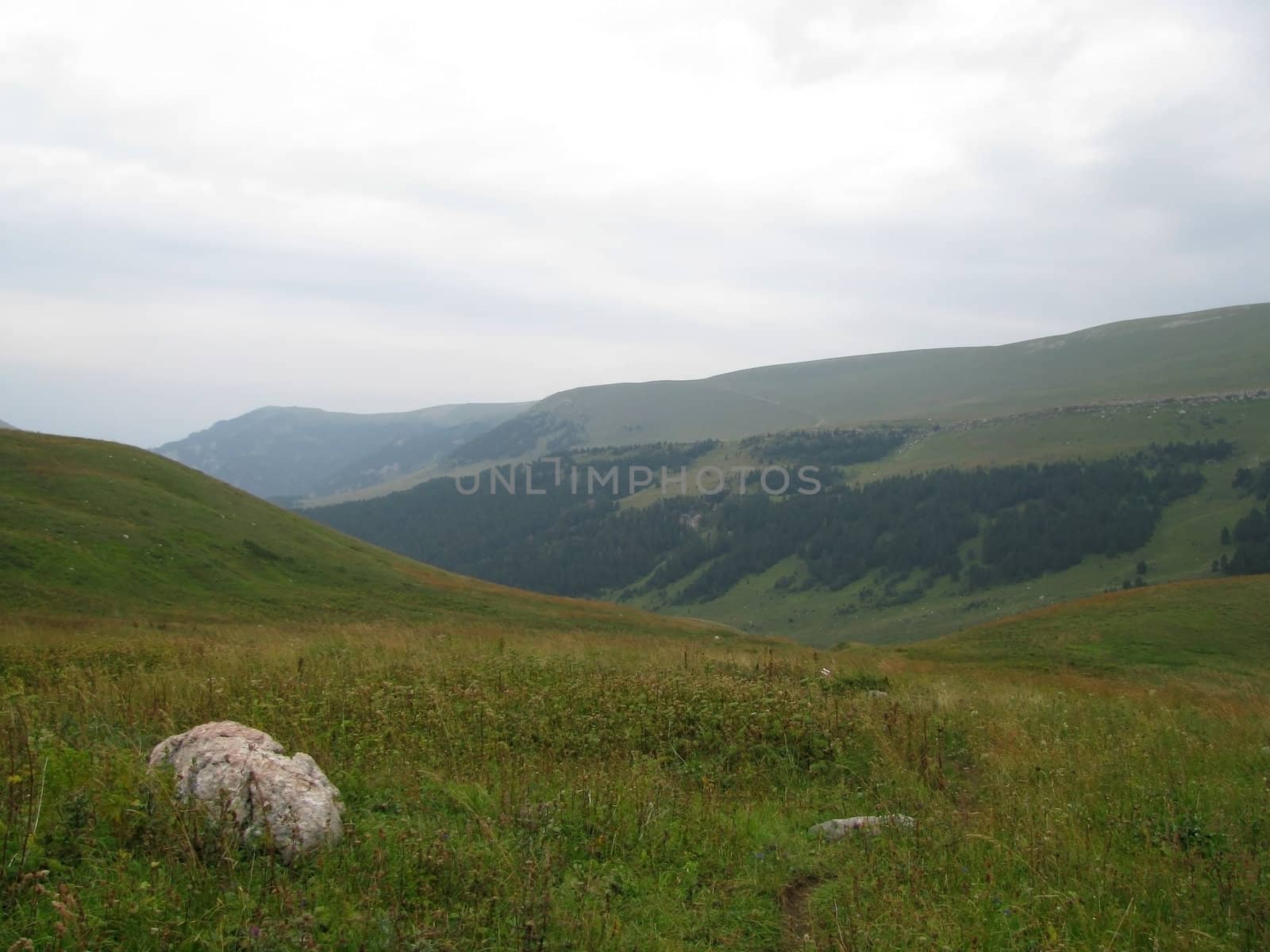 Mountains; rocks; a relief; a landscape; a hill; a panorama; Caucasus; top; a slope; a snow; a cool; clouds