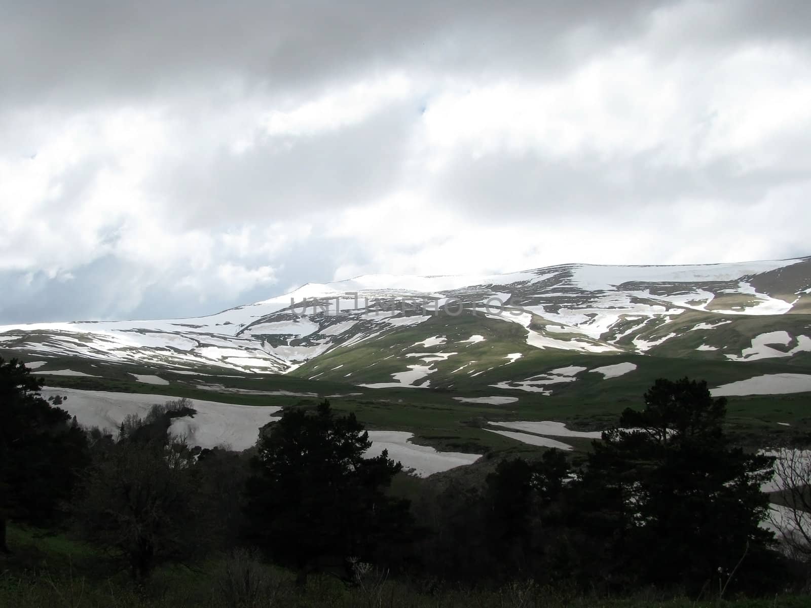 Mountains; rocks; a relief; a landscape; a hill; a panorama; Caucasus; top; a slope; a snow; a cool; clouds