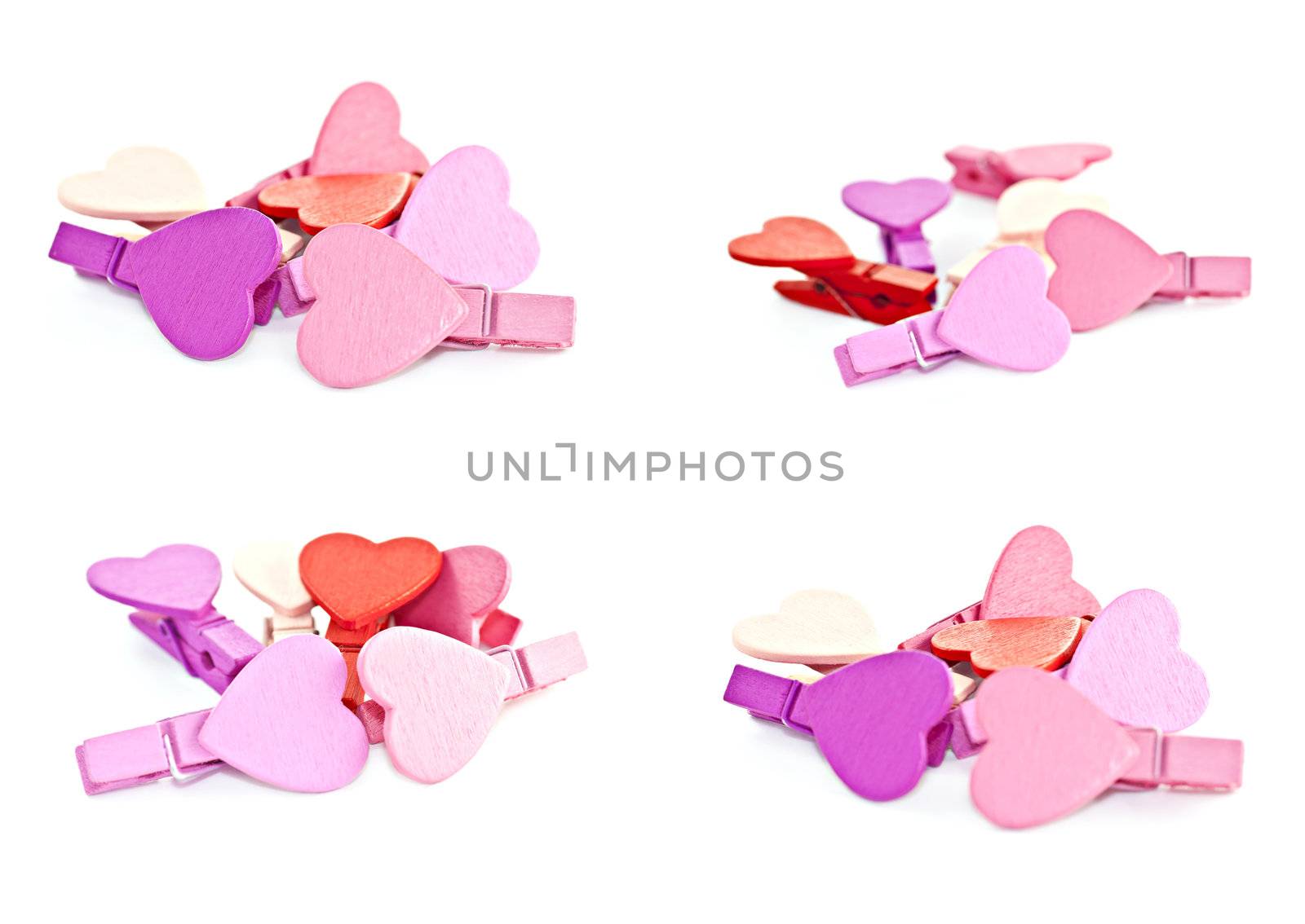 Colorful wooden pegs with a heart on a white background. Macro photography.