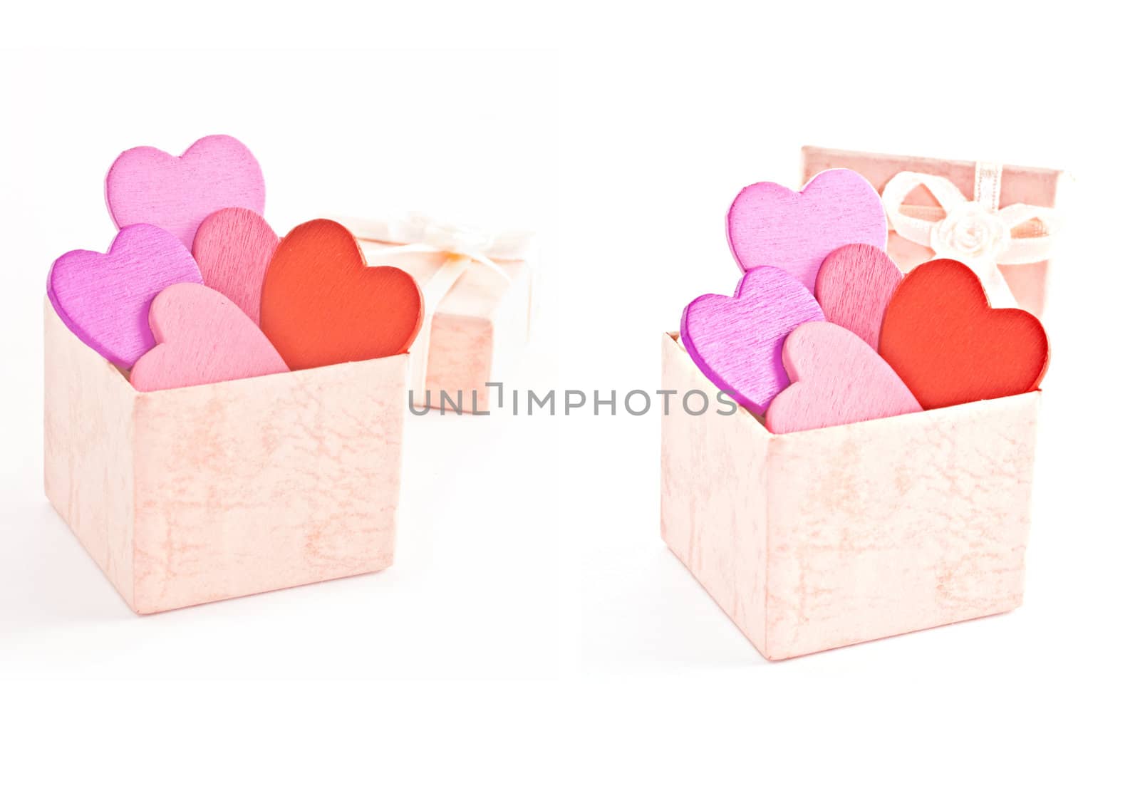Wooden heart-shaped pink color Gift Box on the white background. Macro photo.
