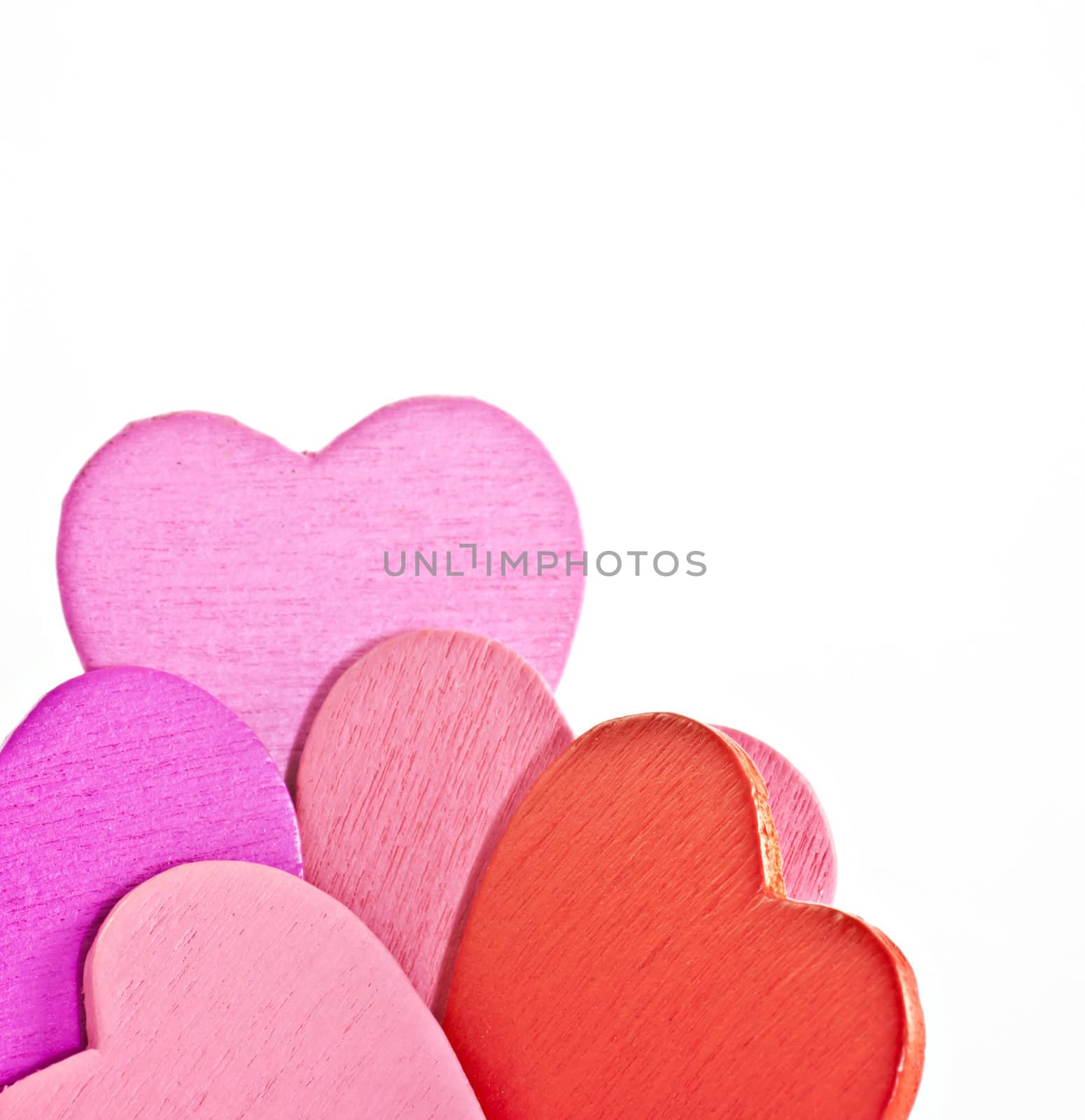 Colorful wooden  heart on a white background. Macro photography.