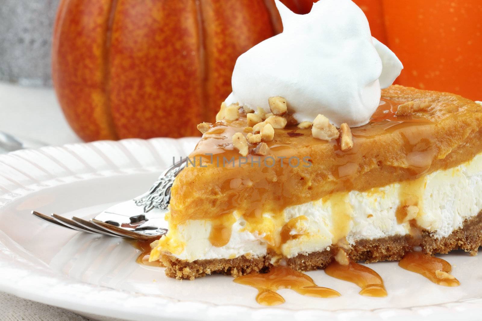Slice of Double Layer No Bake Pumpkin Pie made with pumpkin, vanilla pudding,cream cheese, and whipped cream. 