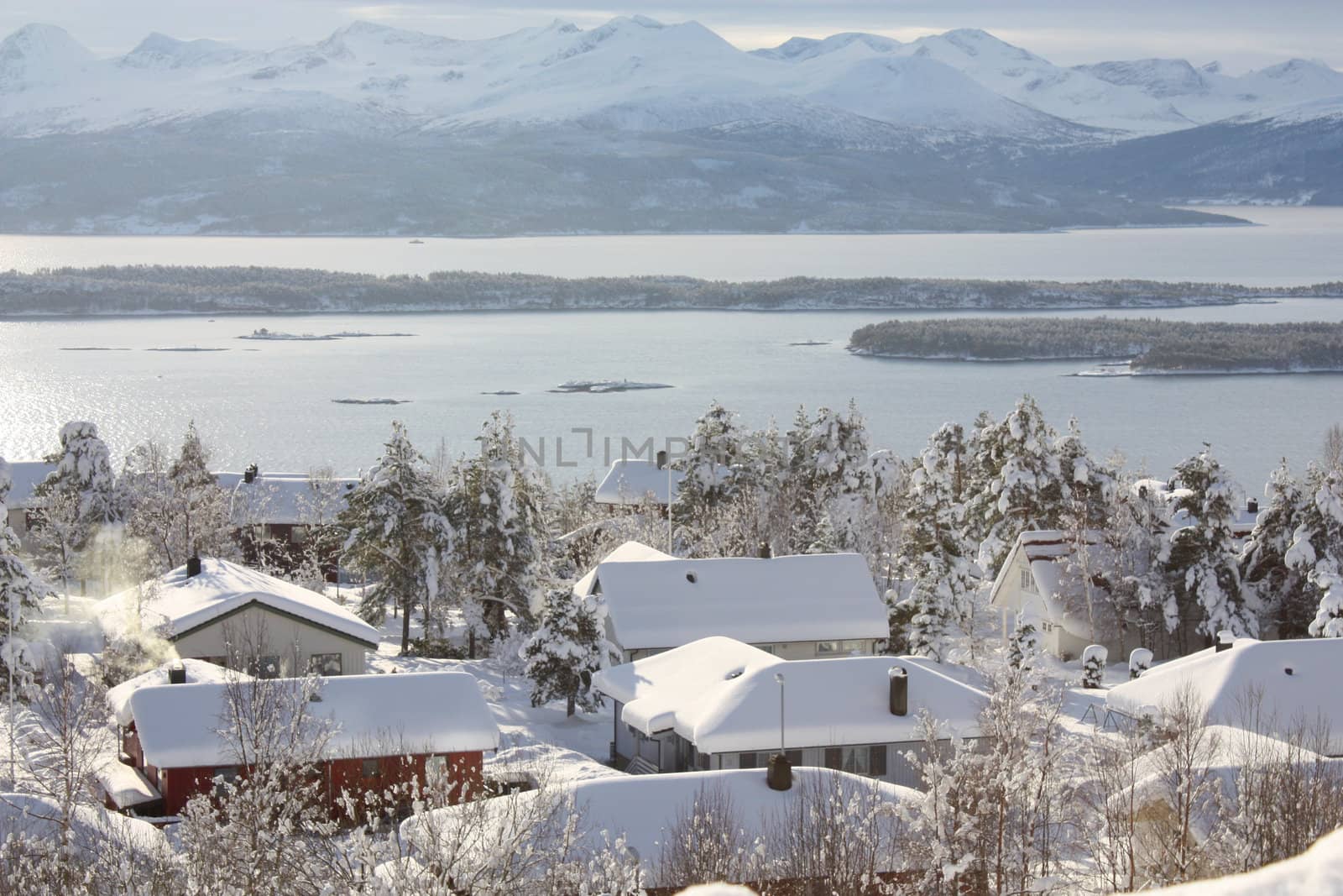 Snowy houses in a white winter landscape in western Norway.