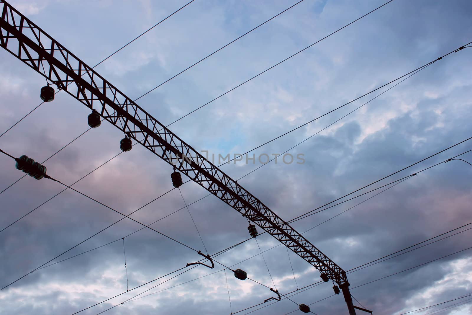 Power line of electric trains on the background of the cloudy