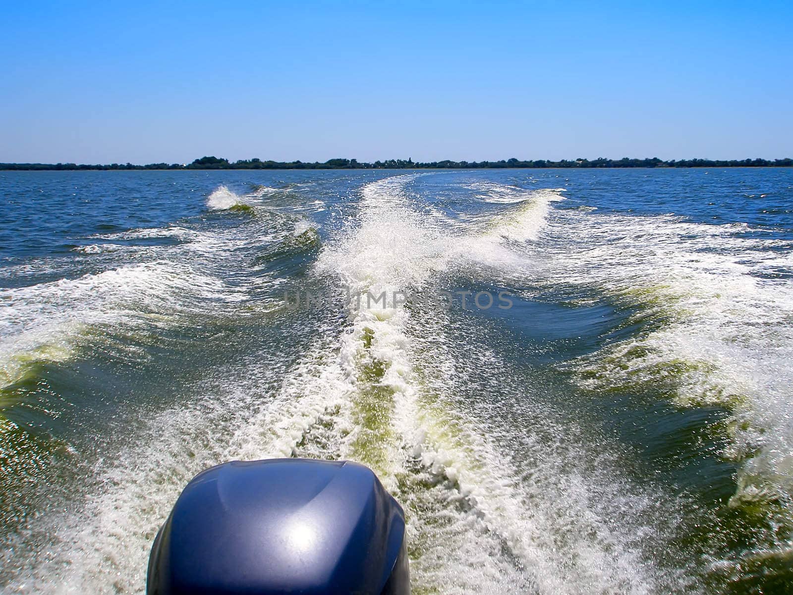 The boat away from shore. Detail of the engine shown