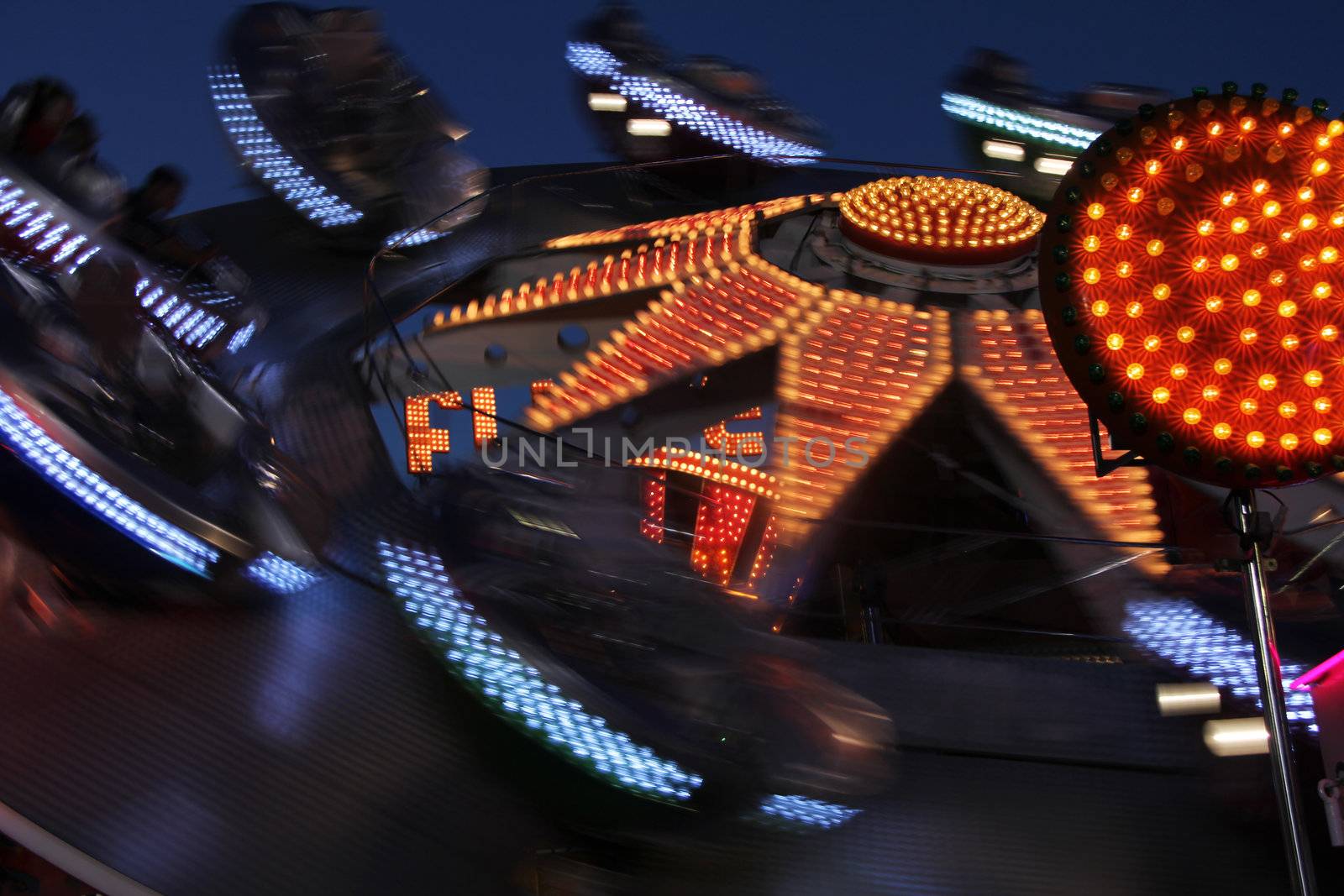 bright colored and fast motion carousel at night