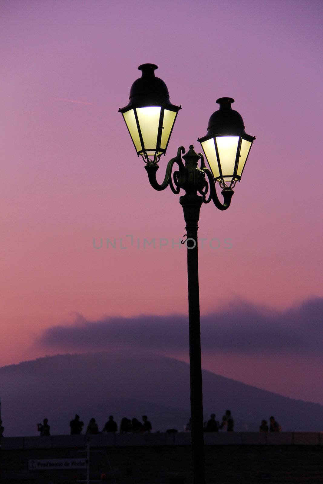 old retro streetlight in front of a mediterranean sunset