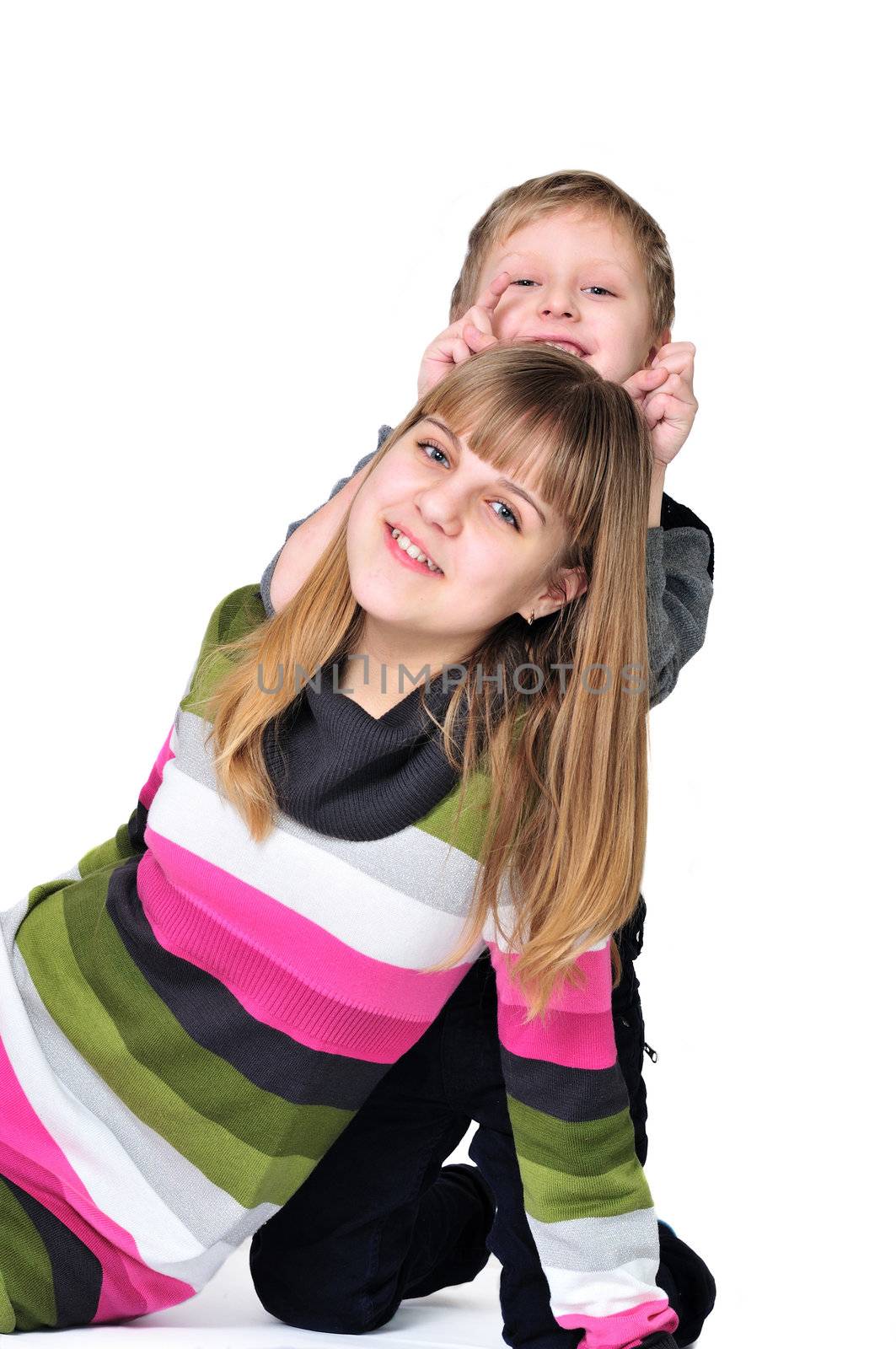 sweet sister and brotherhaving fun on the white background 