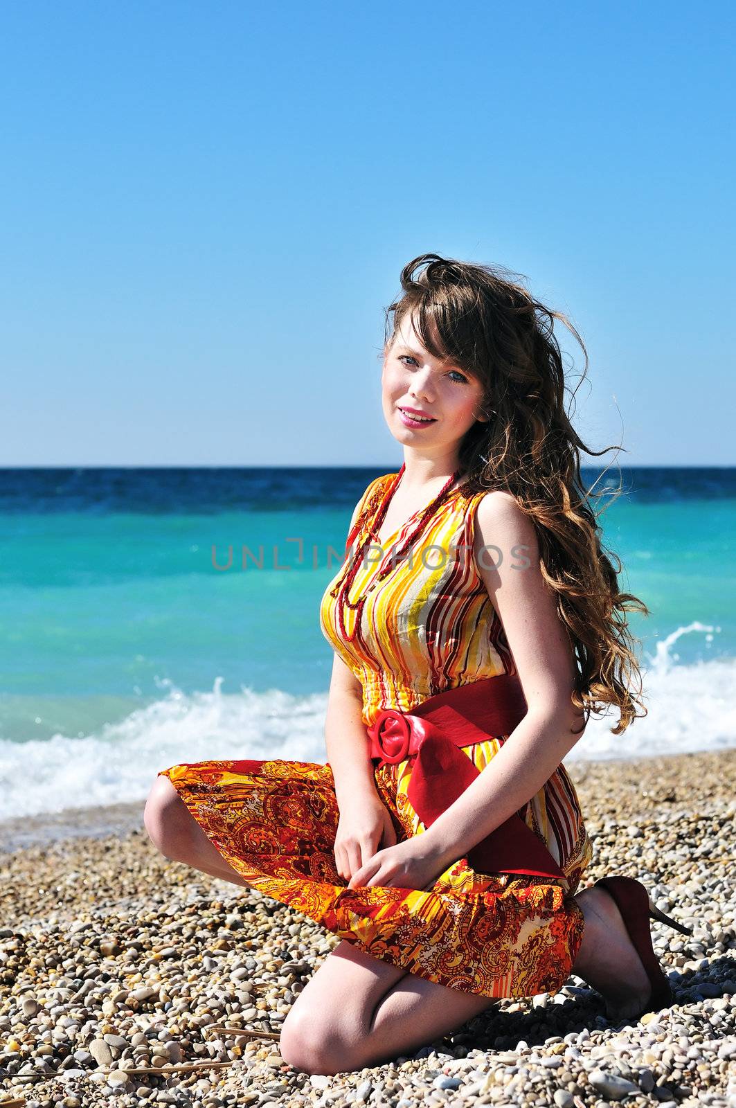 summer beautiful girl sitting near the sea