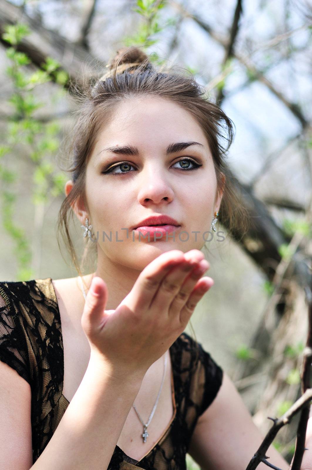  Young pretty teen girl blowing a kiss